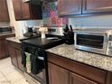 Well-equipped kitchen featuring granite countertops and stainless steel appliances provides ample cooking space at 4056 Campeche Ave, Las Vegas, NV 89121