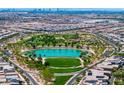 Stunning aerial view of a Primary-planned community with a lake, green spaces, golf course, and homes in the background at 412 Gracious Way, Henderson, NV 89011
