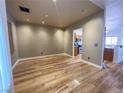 Spacious living room with wood-look floors, recessed lighting, and neutral wall paint at 4126 Jessica Marie St, North Las Vegas, NV 89032