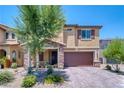 Attractive two-story house with a stone-accented porch, two-car garage, and desert landscaping at 4206 Topaz Hills Dr, North Las Vegas, NV 89032