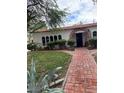 Single-story home with classic design, a brick walkway, and charming front yard landscaping at 4444 Denia Cir, Las Vegas, NV 89108