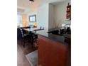 Stylish kitchenette featuring dark countertops and wood flooring adjacent to a comfortable living area at 4525 Dean Martin Dr # 2203, Las Vegas, NV 89103