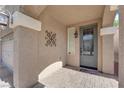 Covered front porch with decorative door, brick pavers, and attractive exterior lighting at 5234 Tulip Hill Ave, Las Vegas, NV 89141
