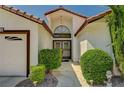 Welcoming entrance with double doors, a modern light fixture, and manicured landscaping at 5401 Broadwater Ln, Las Vegas, NV 89130