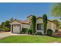 Charming single-story home with well-manicured lawn, mature trees, and a two-car garage at 5401 Broadwater Ln, Las Vegas, NV 89130