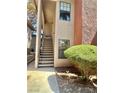 Exterior view of apartment stairs leading to the front door, adorned with verdant shrubbery and a manicured walkway at 5576 W Rochelle Ave # 27A, Las Vegas, NV 89103