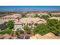 Up close shot of a beautiful townhome with manicured landscaping, tile roof, and a balcony at 5855 Valley Dr # 2106, North Las Vegas, NV 89031