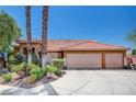 Attractive home exterior with a three-car garage and well-maintained landscaping at 5933 Perfect View St, Las Vegas, NV 89130