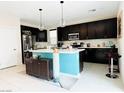 Spacious kitchen boasts a large center island, dark cabinetry, modern appliances, and ample counter space at 6230 Bravestar Ct, Las Vegas, NV 89141