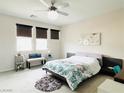 Serene bedroom showcases three large windows, a contemporary ceiling fan, and neutral decor at 6230 Bravestar Ct, Las Vegas, NV 89141