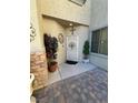 Inviting entryway with decorative door, manicured plants, and stylish stone accents enhance curb appeal at 6329 Kitamaya St, North Las Vegas, NV 89031