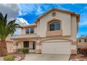 Inviting two-story home with a well-manicured front yard and attached two-car garage at 775 Wigan Pier Dr, Henderson, NV 89002