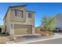 Two-story modern home with a two-car garage, minimalist landscaping, and a brick driveway under a clear sky at 7853 Bethel Heights Ln, Las Vegas, NV 89113
