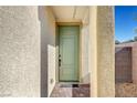 Inviting entryway features a green front door, neutral stucco walls, and brick pavers leading to the entrance at 7853 Bethel Heights Ln, Las Vegas, NV 89113