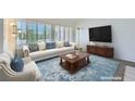 Bright living room with a white couch, plush arm chair, a blue rug, and plantation shutters at 9717 Buckhorn Dr, Las Vegas, NV 89134