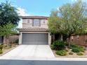 Two-story home featuring a tile roof, gray two-car garage and desert landscaping at , Las Vegas, NV 89141
