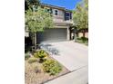 This two-story home boasts a well-maintained front yard and a spacious driveway leading to a two-car garage at , Las Vegas, NV 89141