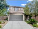 Two-story home featuring a tile roof, gray two-car garage and desert landscaping at , Las Vegas, NV 89141