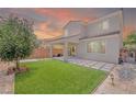 Lush backyard featuring artificial turf, a covered patio, and block wall providing privacy at 1000 Cetona Ct, Henderson, NV 89011
