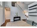 Inviting entryway showcasing high ceilings, modern staircase, and contemporary shelving at 1013 Corsica Ln, Las Vegas, NV 89144