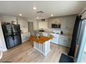 Updated kitchen with stainless steel appliances, wood floors, and a center island at 10331 Ednor St, Las Vegas, NV 89183