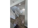 Bright entryway featuring stairs with white railing and tile flooring at 10668 Berkshire Woods Ave, Las Vegas, NV 89166
