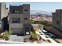Stylish two-story home with desert landscaping, a private courtyard, and a scenic mountain backdrop at 11658 Midnight Melody Ave, Las Vegas, NV 89138