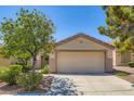 Charming single-story home with a well-maintained lawn, mature trees, and a two-car garage at 2085 Joy View Ln, Henderson, NV 89012
