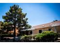 Charming condo featuring a red tile roof, mature trees, and a meticulously landscaped front yard at 2851 S Valley View Blvd # 1130, Las Vegas, NV 89102