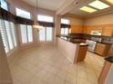 Kitchen and breakfast nook featuring tile floors, ample natural light, and traditional cabinetry at 2925 Big Green Ln, Las Vegas, NV 89134