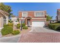 Charming two-story townhome with a tile roof, well-maintained landscaping, and an attached two-car garage at 3221 Epson St, Las Vegas, NV 89129