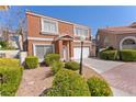 Charming two-story townhome with a tile roof, well-maintained landscaping, and an attached two-car garage at 3221 Epson St, Las Vegas, NV 89129