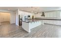 Spacious kitchen featuring a large island, stainless steel appliances, and modern pendant lighting at 397 Pearl Fountains Ct, Las Vegas, NV 89148