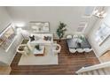 Bird's eye view of a stylish living room featuring a white sofa and dining table with seating at 445 Colorful Rain Ave, North Las Vegas, NV 89031