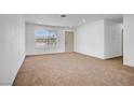 Bright living room with neutral walls, plush carpet, and ample natural light at 4829 Hot Springs Ave, Las Vegas, NV 89110