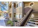 Condo exterior showing private stairway, small landscaped area, and building architectural details on a sunny day at 5052 S Rainbow Blvd # 201, Las Vegas, NV 89118