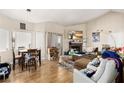 Inviting living room features a fireplace, wood-look flooring, and ample natural light from large windows at 5052 S Rainbow Blvd # 201, Las Vegas, NV 89118