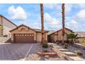 Charming single-story home with desert landscaping, neutral tones, and a two-car garage at 517 Chance Cove Dr, Henderson, NV 89052