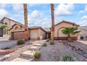 Inviting single-story home with desert landscaping and a pathway to the front door at 517 Chance Cove Dr, Henderson, NV 89052