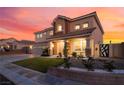 Charming two-story home featuring manicured landscaping and a welcoming front porch at 6209 Exquisite Ave, Las Vegas, NV 89110