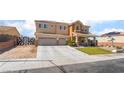 Inviting two-story home with a three-car garage, landscaping, and fenced yard at 6209 Exquisite Ave, Las Vegas, NV 89110