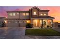 Lovely two-story home with a three-car garage and welcoming front porch at 6209 Exquisite Ave, Las Vegas, NV 89110