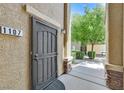 Inviting front door with security screen and desert landscaping, creating a warm welcome at 6868 Sky Pointe Dr # 1107, Las Vegas, NV 89131