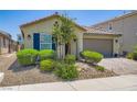 Well-kept single-story home with an arched entryway, tile roof, and desert landscaping at 7224 Piute Mesa St, North Las Vegas, NV 89084