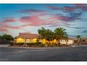 Attractive exterior view of a home showcasing its well-maintained lawn, desert landscaping, and spacious two-car garage at 8650 W Verde Way, Las Vegas, NV 89149