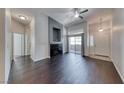 Spacious living room with dark hardwood floors, modern fireplace, and sliding glass door at 8805 Jeffreys St # 1048, Las Vegas, NV 89123
