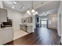 Open-concept living space featuring dark hardwood floors, modern fireplace, and kitchen at 8805 Jeffreys St # 1048, Las Vegas, NV 89123