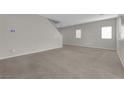 Spacious living room with carpet, neutral walls, and plenty of natural light at 9024 Hazy Haven Ct, Las Vegas, NV 89149