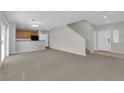Spacious open-plan living area with modern finishes and stairs at 9024 Hazy Haven Ct, Las Vegas, NV 89149