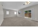 Living room with neutral walls, carpet, and sliding glass doors to the patio at 9024 Hazy Haven Ct, Las Vegas, NV 89149